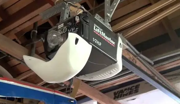 Professional technician repairing a garage door opener in Orlando, FL, showcasing expert garage door services for residential properties."