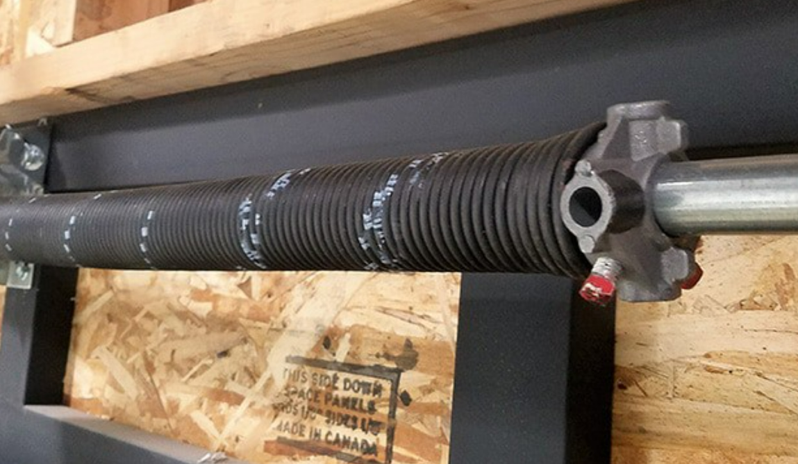 a professional technician repairing a garage door spring in Orlando, FL, emphasizing quality garage door repair services.